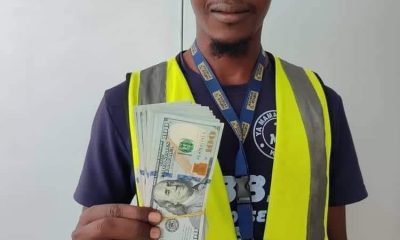 Auwal Ahmed Dankode, Airline cleaner, displays $10,000 found in a plane