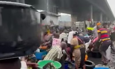 Safety fears as crowds rush to scoop fuel as petrol tanker overturns in Apapa